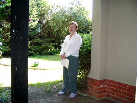Mary standing in the house porch in April 2005